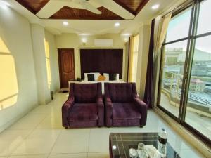 a living room with a couch and a bed at Swat Hilton Hotel by Khan Familia in Swat