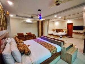a bedroom with a large bed with tiger pillows at Swat Hilton Hotel by Khan Familia in Swat