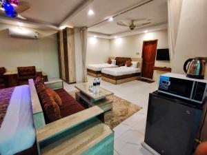 a living room with a couch and a microwave at Swat Hilton Hotel by Khan Familia in Swat +36 photos