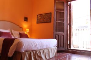 a bedroom with a bed and a large window at Casa Rural El Gaiter in Aguaviva
