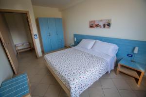 a small bedroom with a bed and a blue cabinet at Residence Miljunka in SantʼAgata di Militello