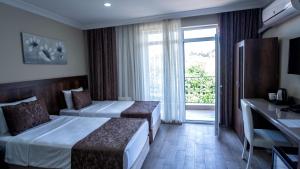 A bed or beds in a room at MAÇA OTEL Még 37 kép