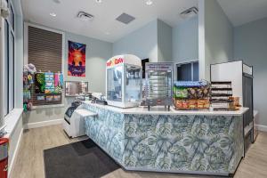 a store counter with a soda machine and food at Star Wars Moana Princess Mario Avatar Near Disney in Davenport