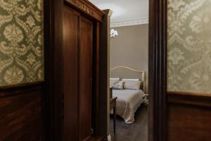 a bedroom with a bed and a door leading into a room at B&B Locanda della Vittoria in Catania