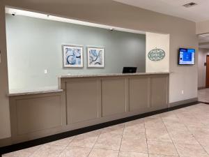 a waiting room with a counter and a tv at Best Western Inn & Suites Cleveland in Cleveland