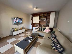 a living room with a couch and a teddy bear at Vila 8 oaspeti in Bucharest