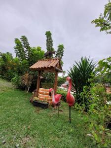 two fake birds standing in front of a gazebo at loft harmonia in Blumenau