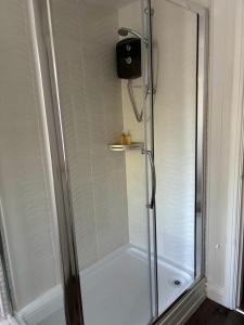 a shower with a glass door in a bathroom at Exquisite Long-Term Living in Cardiff's Heart in Cardiff