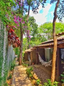 a house with a hammock in front of it at Morada dos Saguis in Alto Paraíso de Goiás