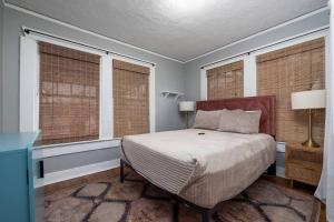 a bedroom with a bed and two windows at The Pond Pad at Crestwood in Birmingham