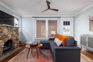 a living room with a couch and a fireplace at The Pond Pad at Crestwood in Birmingham