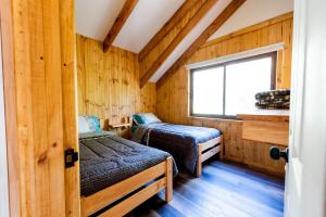 a room with two beds and a window at TERMAS DE CHILLAN Las Trancas in Chillán
