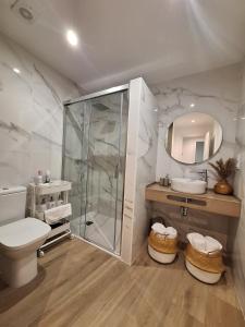 a bathroom with a shower and a toilet and a sink at Aromas del Jiloca, la Trufa Negra in Calamocha