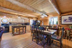 a kitchen with wooden floors and a table and chairs at Philipsburg Log Cabin - Direct Bike Park Access! in Georgetown