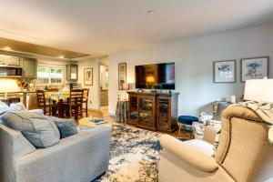 a living room with a couch and chairs and a kitchen at Peaceful Renton Retreat with Hot Tub Access! in Renton