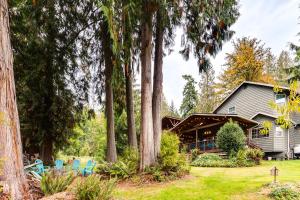 a house with trees in front of it at Peaceful Renton Retreat with Hot Tub Access! in Renton