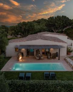 a villa with a swimming pool and a house at Stazzo Lu Ciaccaru in Arzachena