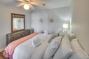 a bedroom with a large white bed with a couch at Murrells Inlet Vacation Rental about 4 Mi to the Beach in Myrtle Beach