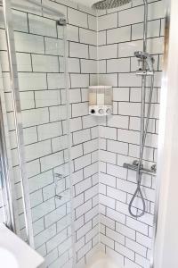 a bathroom with a shower with white subway tiles at Little Garden View in St. Albans