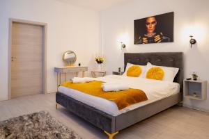 a bedroom with a large bed and a mirror at Casa Paul in Braşov