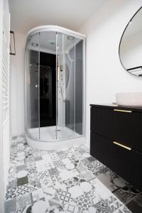 a bathroom with a glass shower and a sink at Casa Paul in Braşov