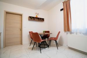 a dining room with a table and chairs at Casa Paul in Braşov