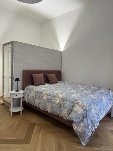 a bedroom with a large bed with a blue blanket at Kaštieľ Ladce 