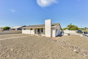 a house with a gravel driveway in front of it at Sunny Yuma Vacation Rental with Private Pool! in Yuma