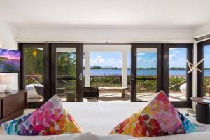 a living room with a couch and a view of the water at Songbird 4 BR Anguilla Villa in The Valley