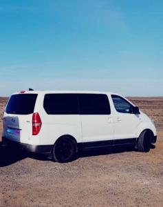 a white van is parked in the desert at FurgoCamper Van H1 in Tetir