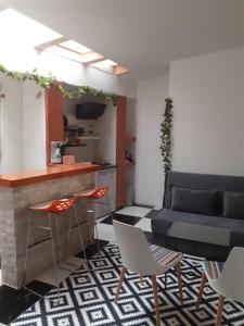 a kitchen with a table and chairs and a couch at Apartmani Zaara in Sarajevo