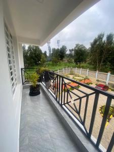 a balcony with a railing with a view of a yard at Meru Heights in Meru