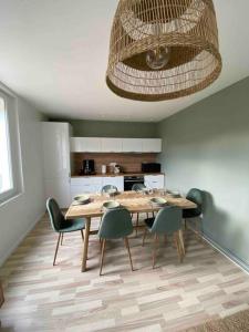 a kitchen with a table and chairs in a room at Maison de ville epernay avec grande terrasse in Épernay