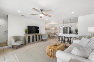 a living room with a couch and a tv at Sand Buckets Unit B, Ocean View Beach Townhouse in Mexico Beach
