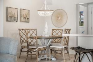 a dining room with a table and chairs at Sand Buckets Unit B, Ocean View Beach Townhouse in Mexico Beach