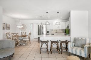 a kitchen and living room with a bar and chairs at Sand Buckets Unit B, Ocean View Beach Townhouse in Mexico Beach
