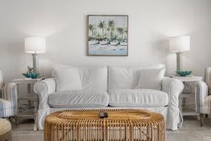 a living room with a white couch and a table at Sand Buckets Unit B, Ocean View Beach Townhouse in Mexico Beach