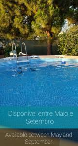 a swimming pool with a sign that readsemetery between may and september at Quinta dos Viegas in Faro