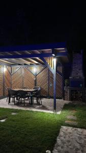 a group of picnic tables in a patio at night at Ensagardenbungalov in Kartepe