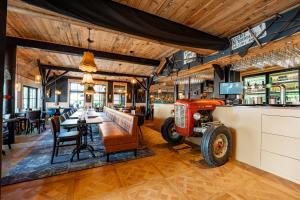 a bar with an old tractor in a restaurant at Boetiekhotel Faan in Ballum