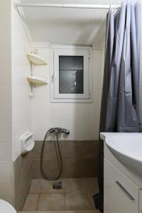 un baño con ducha y lavabo en Athens Retreat 1-BDR Apartment by WeHost Athens, en Atenas