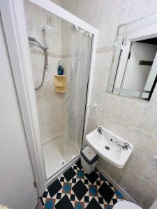 a bathroom with a sink and a shower and a toilet at Double bed Small En-suite for 2 in Killybegs