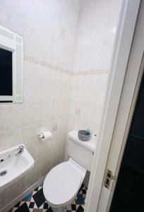 a bathroom with a white toilet and a sink at Double bed Small En-suite for 2 in Killybegs
