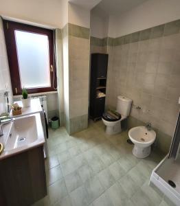 a bathroom with a toilet and a sink at Di Gioia Home B&B in Cosenza