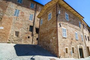 a large brick building with a large door at B&B La Locanda del Serafino in Sarnano