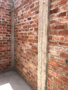 a brick wall next to a brick wall at Acogedora Casa en Trujillo Moche in Trujillo