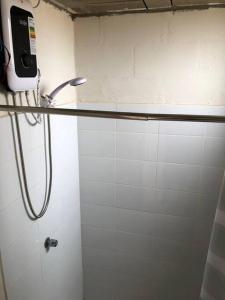 a bathroom with a shower with a phone on the wall at Acogedora Casa en Trujillo Moche in Trujillo