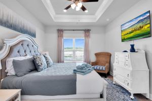 a bedroom with a bed and a dresser and a window at Minutes to Beach ,Golf Cart Included, Ocean View Pool ,Beach Equip, Ocean Therapy in Saint Joe Beach