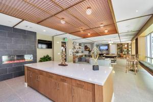 a large kitchen with a counter and a living room at Midtown Houston Luxury Suite at River Oaks in Houston +29 photos