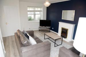 a living room with a couch and a fireplace at Gorgeous 3 bed house in Bristol in Bristol
